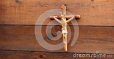 Religious crux handcrafted in clay over some wood wall Stock Photo