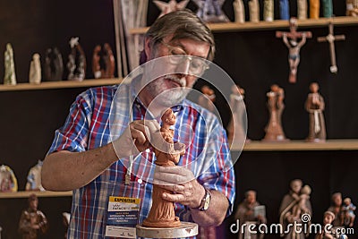 Religious figurine artisan in fair Editorial Stock Photo