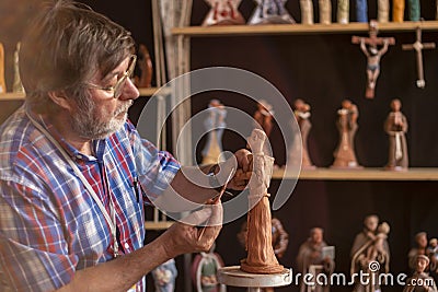 Religious figurine artisan in fair Editorial Stock Photo