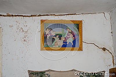 Religious icon in a village hut on a ruined wall. Consequences of the war Editorial Stock Photo