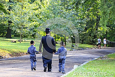 Religious Jew. A family of Hasidic Jews, a man with children, walks through the Autumn Park in Uman, Ukraine, Jewish New Year Editorial Stock Photo