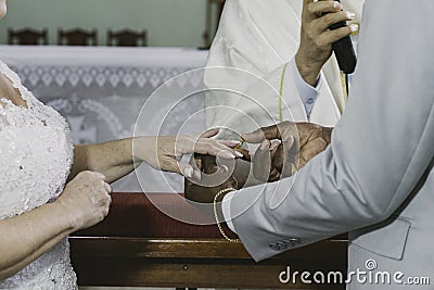 Religious moment of the exchange of alliances during the marriage in the catholic church Stock Photo