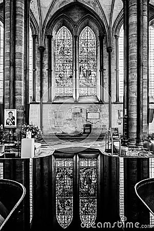 Religious stained glass windows reflected on fountain water surface inside Salisbury Cathedral Editorial Stock Photo