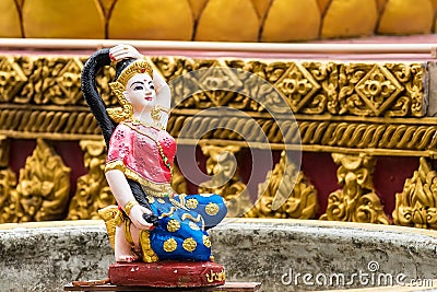 Religious statue at fountain, Thailand. Mother Earth Squeezing Her Hair Stock Photo
