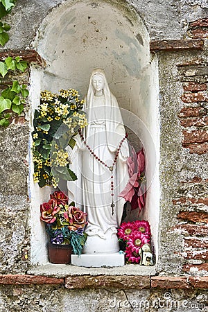 Religious Statue of Mary with Offerings of Worshipers in Form of Stock Photo