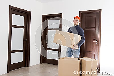Relocation services man with cardboardboxes. Worker transporting things in the apartment. Moving to a new house concept Stock Photo