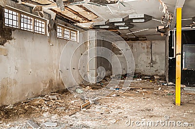 Remains of abandoned damaged and destroyed house interior by grenade shelling with collapsed roof and wall in the war zone selecti Stock Photo