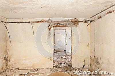 Remains of abandoned damaged and destroyed house interior by grenade shelling with collapsed roof and wall in the war zone selecti Stock Photo