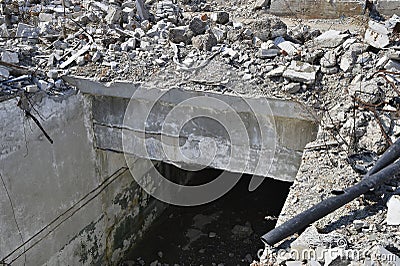 The remains of a destroyed tunnel with a pile of concrete stones destroyed building. Background Stock Photo