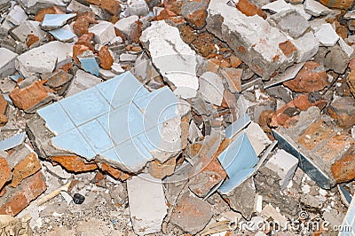 Remains of the destroyed wall in the form of stones, bricks,tiles. Background Stock Photo