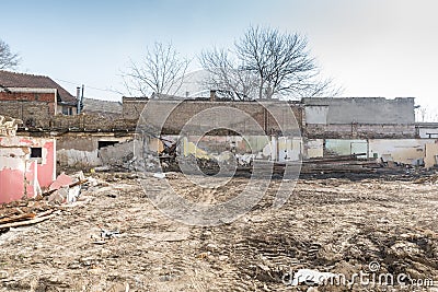 Remains of hurricane or earthquake aftermath disaster damage on ruined old houses with collapsed roof and wall Stock Photo