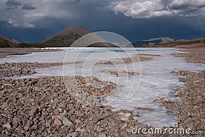 Remains of ice in the valley of a mountain river. Stock Photo