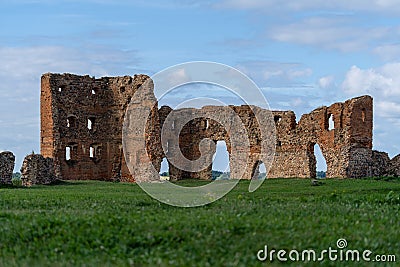 Remains of Ludza castle ruins on the foreground of green grass and blue sky Stock Photo
