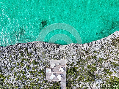 Remarkable view captured from a drone above a secluded, serene deck nestled along the rocky shore. Stock Photo