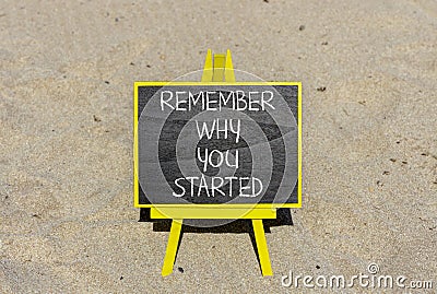 Remember why you started symbol. Concept word Remember why you started on beautiful black chalk blackboard. Beautiful sand beach Stock Photo