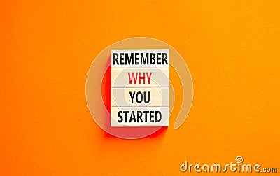 Remember why you started symbol. Concept word Remember why you started on beautiful wooden block. Beautiful orange table orange Stock Photo