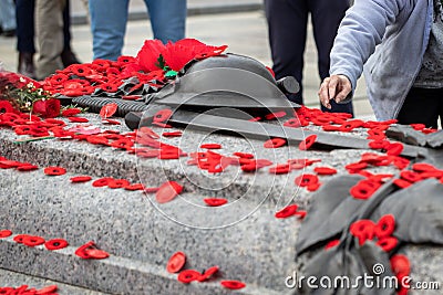 People putting poppy flowers on Tomb of the Unknown Soldier in Ottawa. Remembrance Day in Canada. Editorial Stock Photo