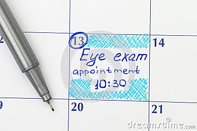 Reminder Eye exam appointment in calendar with pen Stock Photo