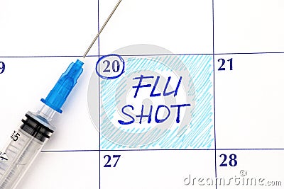 Reminder Flu Shot in calendar with syringe Stock Photo