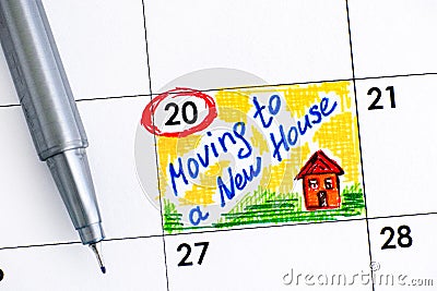 Reminder Moving to a New House in calendar with pen. Stock Photo