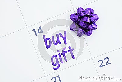 Buy gift text an a monthly calendar with a purple bow Stock Photo