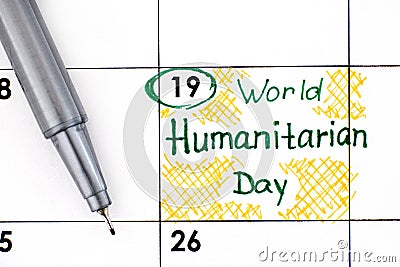 Reminder World Humanitarian Day in calendar with pen Stock Photo
