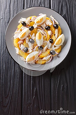 Remojon granadino, salt cod orange and olive salad, spanish cuisine close-up in a plate. Vertical top view Stock Photo