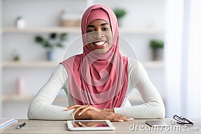 Remote Career. Black Female In Hijab Sitting At Desk With Digital Tablet Stock Photo