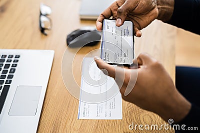 Remote Check Deposit Using Mobile Remote Stock Photo