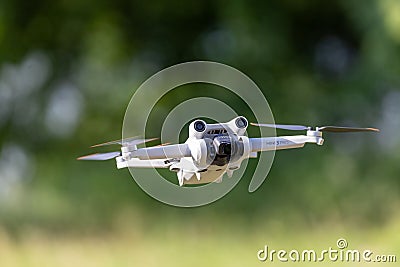 Remote-controlled drone hovers in the sky, capturing aerial footage Editorial Stock Photo
