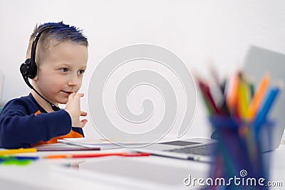 Remote learning concept with boy using laptop. Little boys attending to online school class Stock Photo