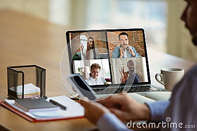 Remote meeting. Man working from home during coronavirus or COVID-19 quarantine, remote office concept. Stock Photo