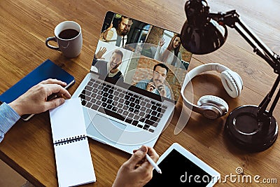 Remote meeting. Man working from home during coronavirus or COVID-19 quarantine, remote office concept. Stock Photo