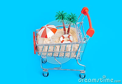 Remote tropical island in a small shopping trolley on blue Stock Photo