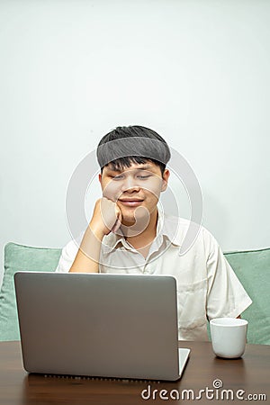 Remote work concept, Male freelancer thinking about business project and working on laptop at home Stock Photo
