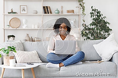 Remote Work. Millennial african american woman working on laptop at home Stock Photo