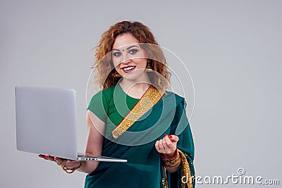 Remote working concept dream job.beautiful and young indian businesswoman green stylish sari working with a laptop while Stock Photo