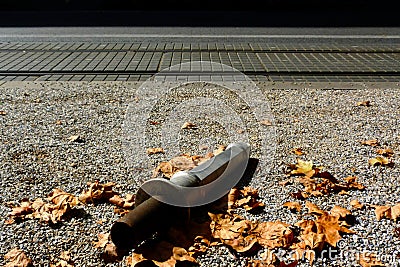 Removable steel and aluminum retro style street bollard on the ground in urban setting Stock Photo