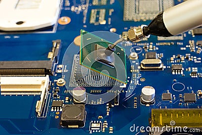 Removal of the chip by vacuum tweezers. Work on the disassembling of electronic components Stock Photo