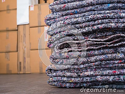 A removal van, showing fabric blankets and cardboard boxes. Moving home. Stock Photo