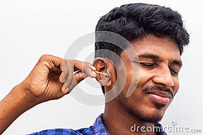 Remove Ear wax Safely - Man cleaning ear with cotton swabs closeup shot. Cleaning ear with cotton bud Dirty ear. Removing ear wax Stock Photo