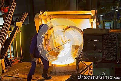 Remove from electric induction crucible melting furnace Editorial Stock Photo