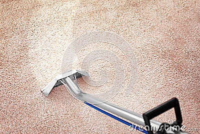 Removing dirt from carpet with professional cleaner indoors Stock Photo