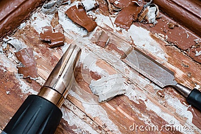 Removing paint from the floor with a hot air gun repair tools Stock Photo