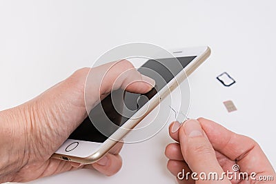 Removing a sim card out of a smartphone, replacing simcard and changing number Stock Photo