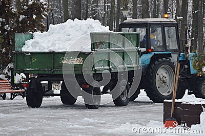 removing snow with a tractor Editorial Stock Photo