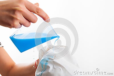 Removing stain from white shirt measuring determent by hand Stock Photo