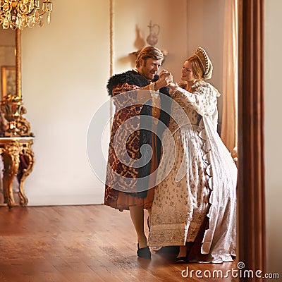 Renaissance, man and woman dance in castle together with vintage love, romance and banquet performance. Medieval king Stock Photo