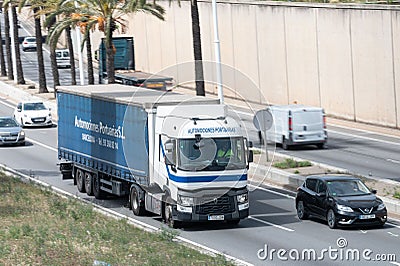 Renault Magnum truck loading a blue container trailer along Barcelona's Ronda Litoral Editorial Stock Photo