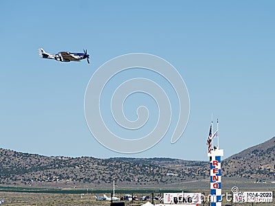 P-51 Mustang flying over the Air Race Finisher podium in Reno. Editorial Stock Photo